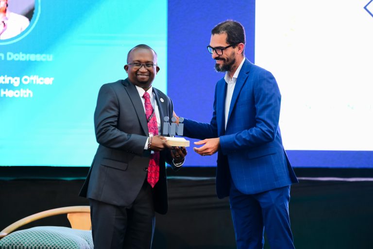 Harrison Muiru, Group Managing Director, Smart Applications International Ltd, receives the award from Gael Aliphon, Senior Manager – Life (SWAN).